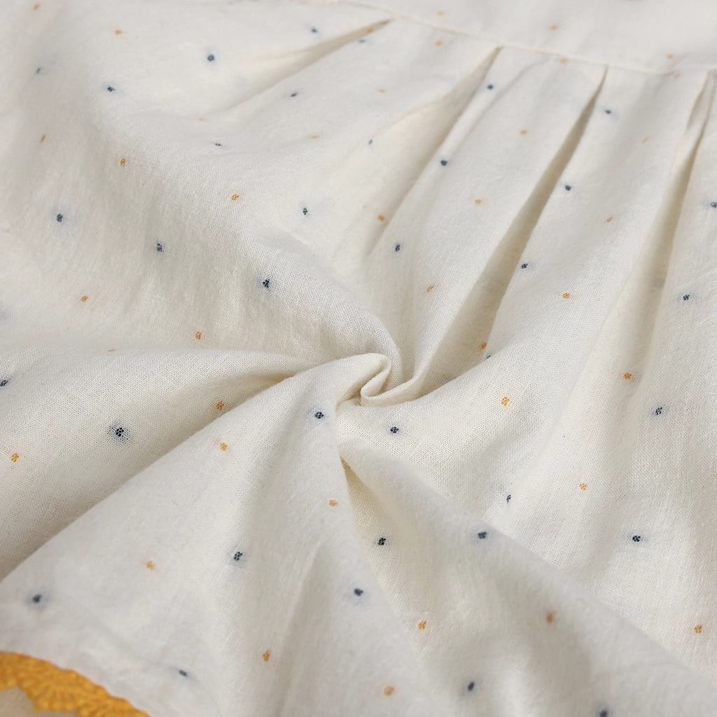 Close-up of textured fabric with small specks on a white background