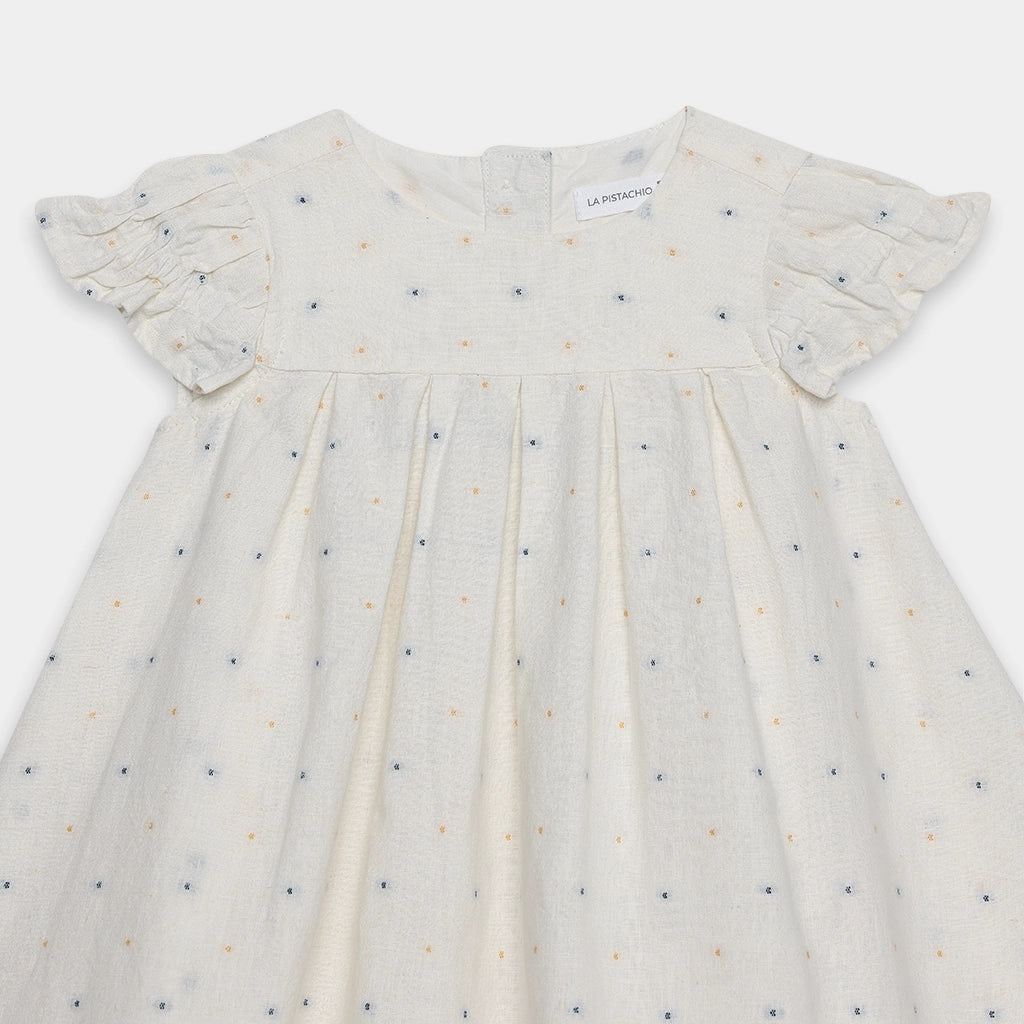 White dress with small patterns on a white background