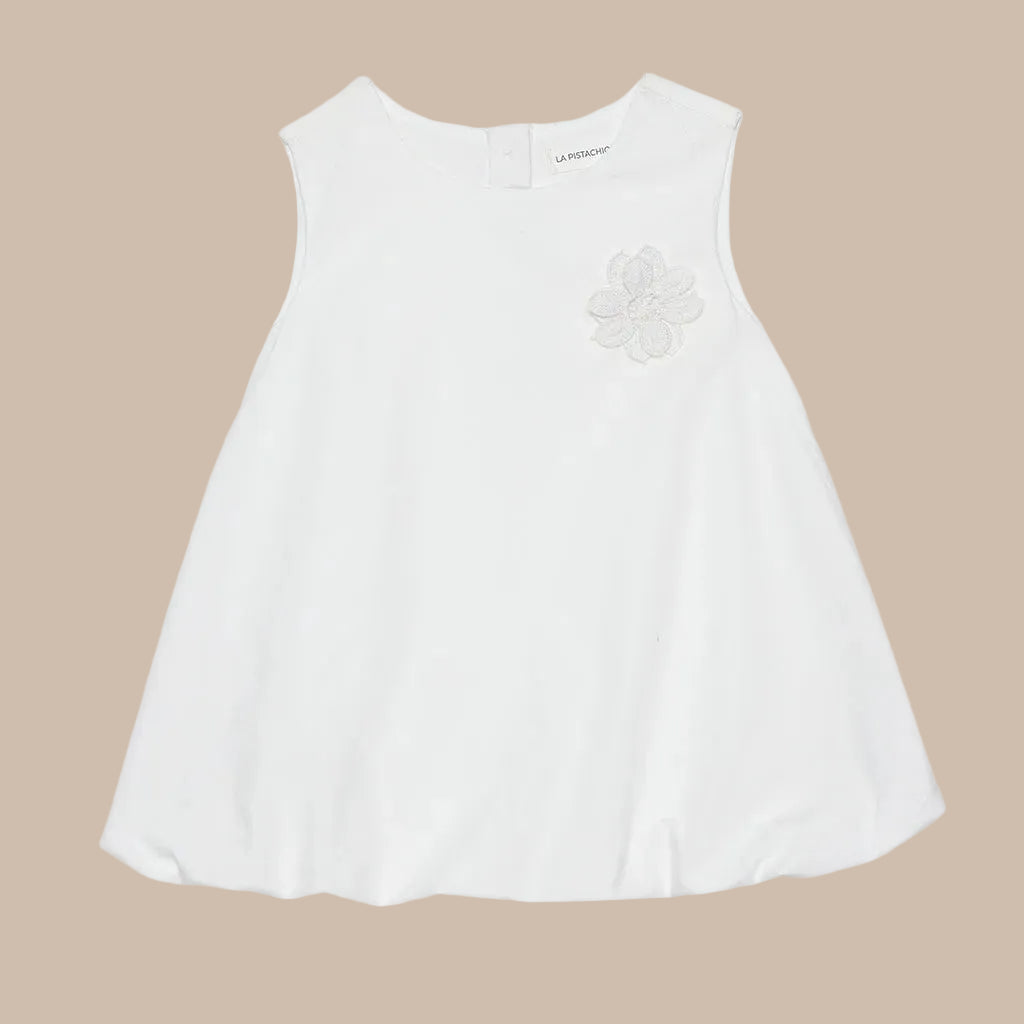 White sleeveless top with floral design on a light gray background