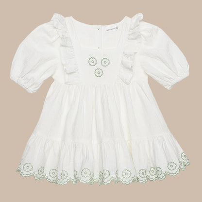 White dress with floral lace details on a white background