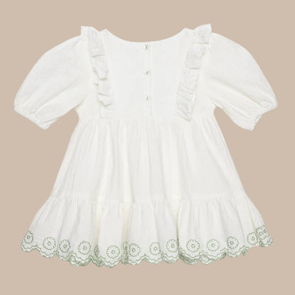 White dress with lace trim on a light gray background