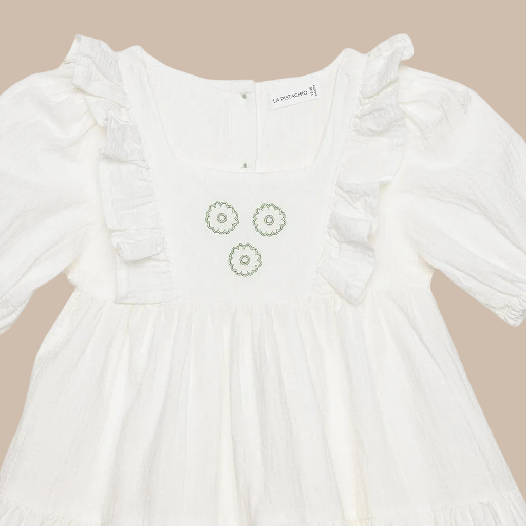 White dress with floral embroidery on a white background