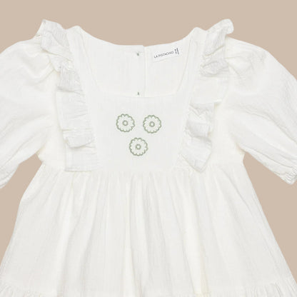 White dress with floral embroidery on a white background
