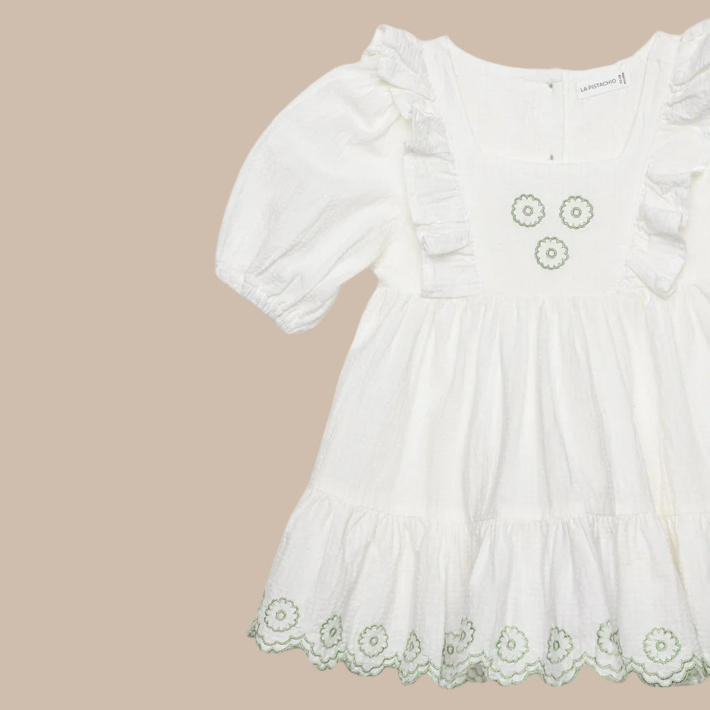 White dress with floral embroidery on a white background