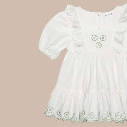White dress with floral embroidery on a white background