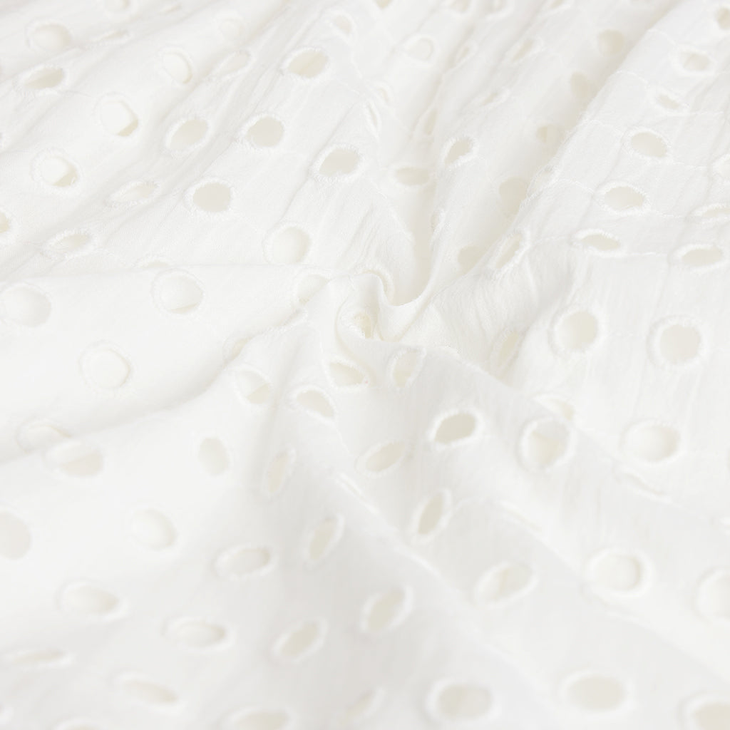 Close-up of a textured white surface with circular patterns