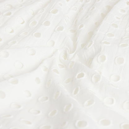 Close-up of a textured white surface with circular patterns