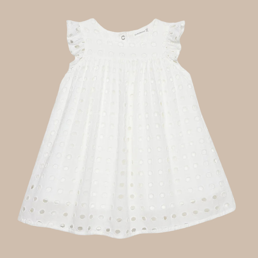 White dress with floral details on a light gray background