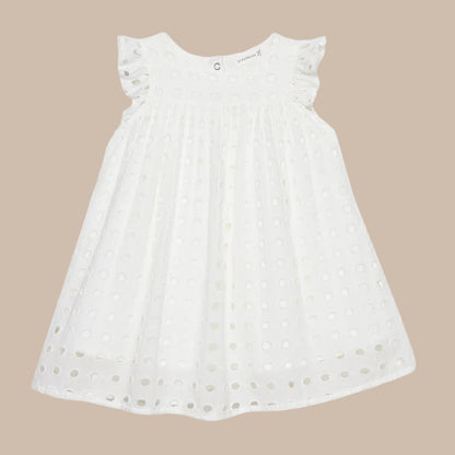 White dress with floral details on a light gray background