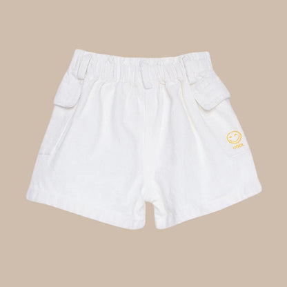 White shorts with a yellow logo on a light gray background