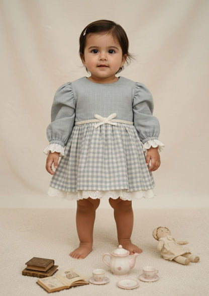 Baby girl standing wearing blue gingham princess cotton dress