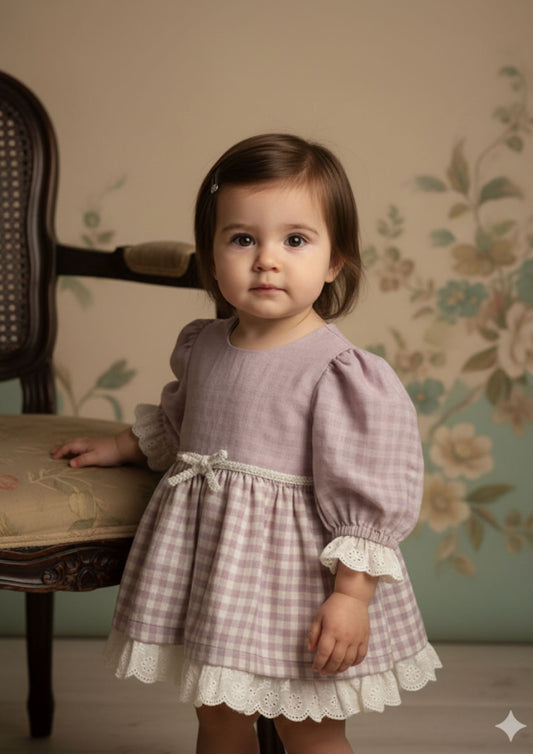 Baby girl standing with hand on chair wearing lavender royale princess cotton dress with hakoba lace