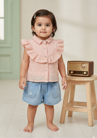Baby girl standing facing front wearing peach sleeveless accoba top and light blue denim torn shorts