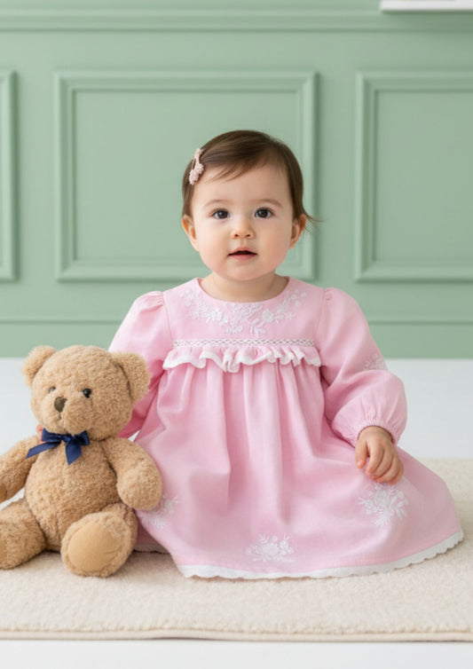 Baby girl sitting wearing petal pink cotton A-line dress with crochet lace