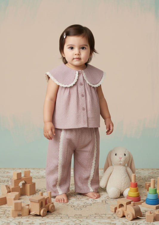 Baby girl standing wearing pink tiny checks cotton co-ord set with Peter Pan collar