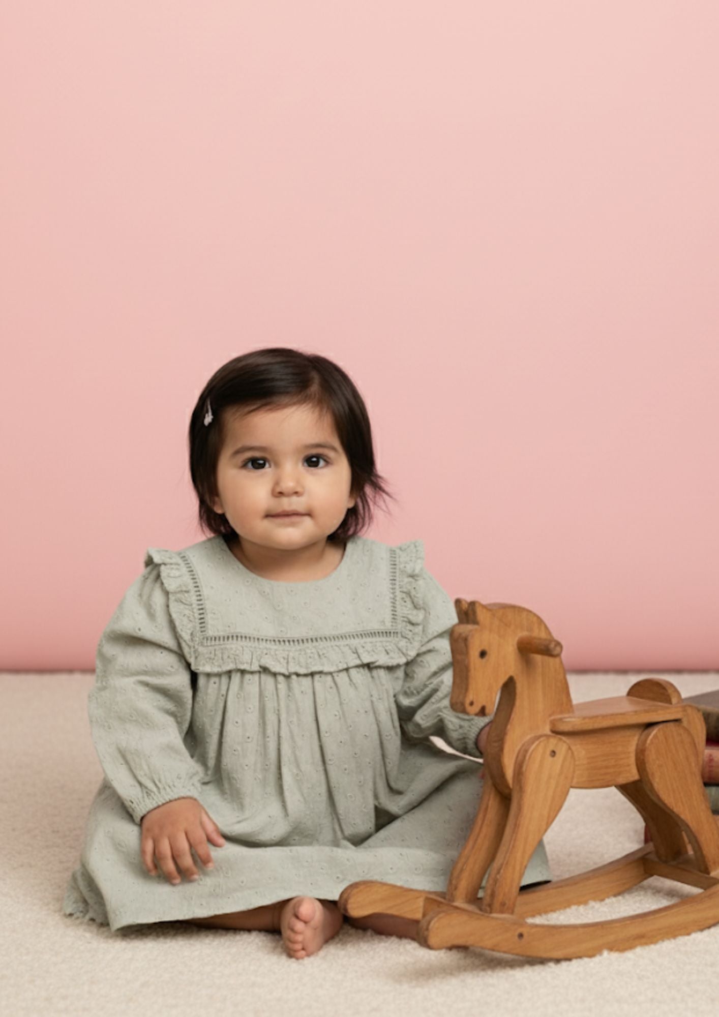 Baby girl sitting wearing sage hakoba cotton A-line dress