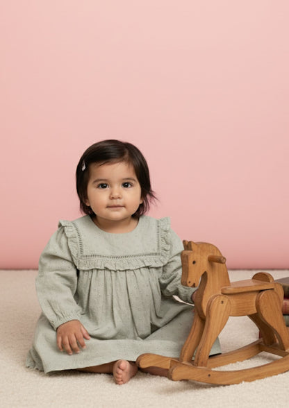 Baby girl sitting wearing sage hakoba cotton A-line dress