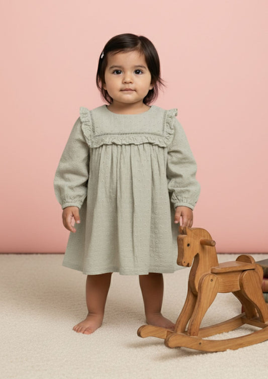 Baby girl standing wearing sage hakoba cotton A-line dress